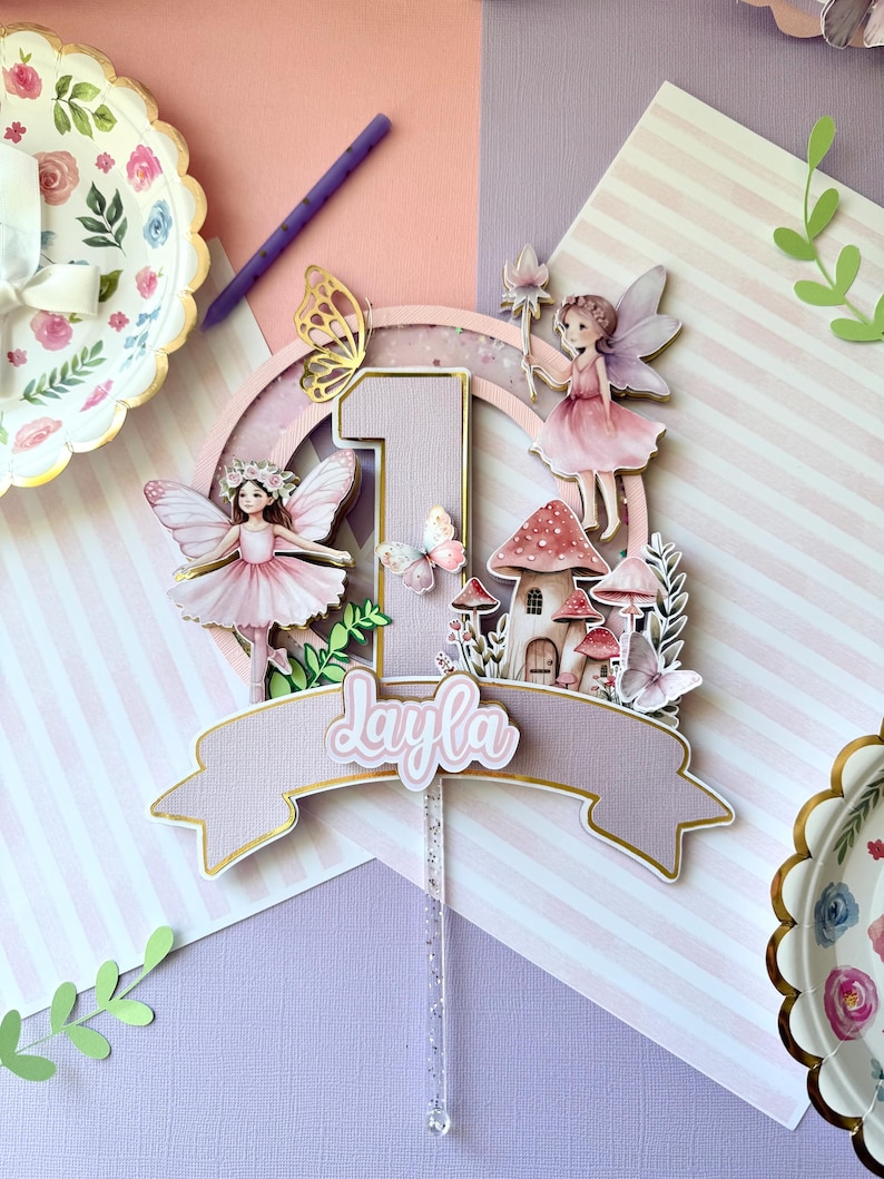 Layla fairy garden first birthday topper with pink fairies, mushrooms and butterflies